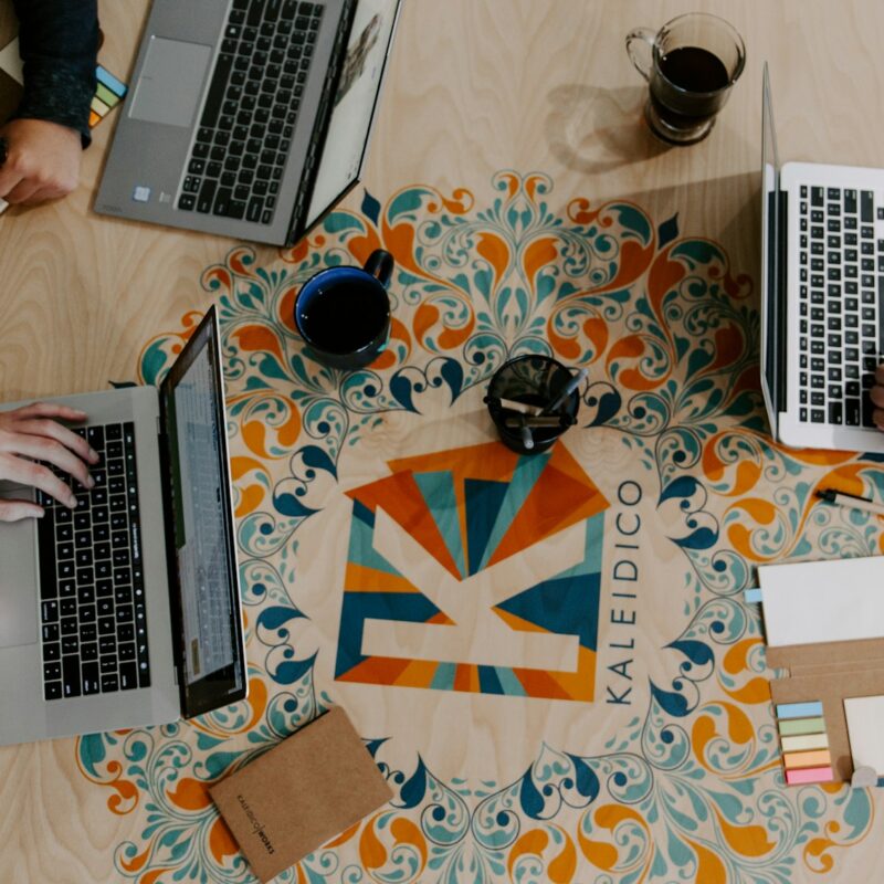 three person using laptops